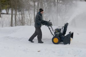 man using Poulan Pro PR241 Electric Start Snow Blower