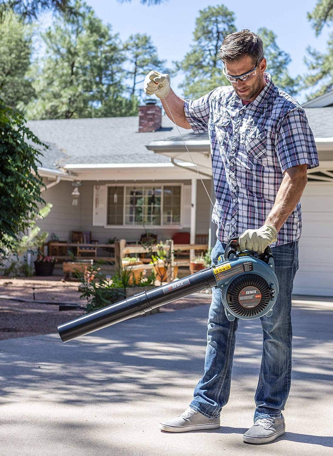 man using SENIX BL4QL-L 4 Stroke Gas Powered Leaf Blower
