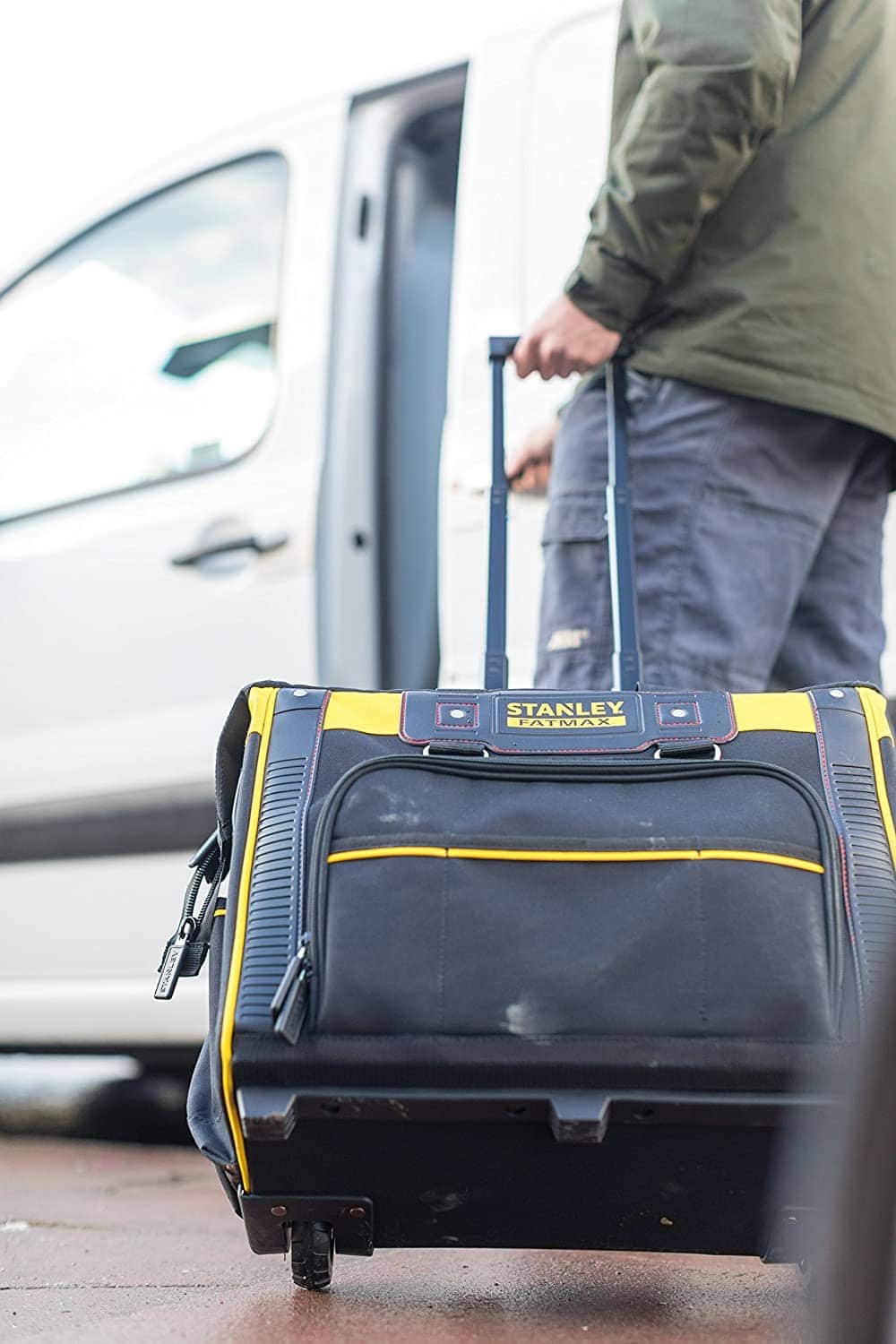 man using STANLEY FMST1-80148 Fat Max Rolling Bag