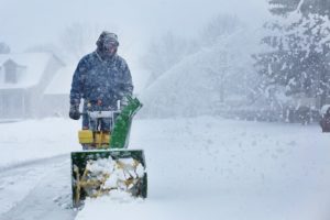 man using snow blower