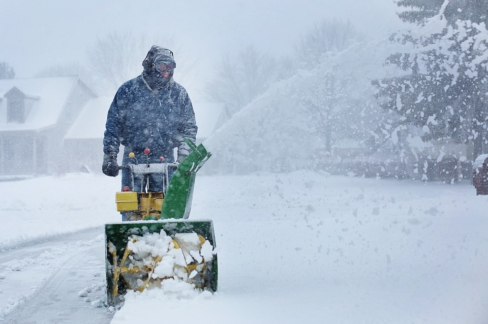 man using snow blower