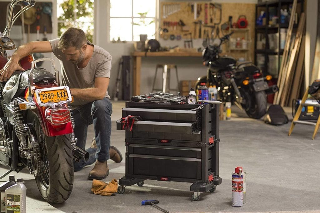 man with Keter 240762 Rolling Tool Chest beside him