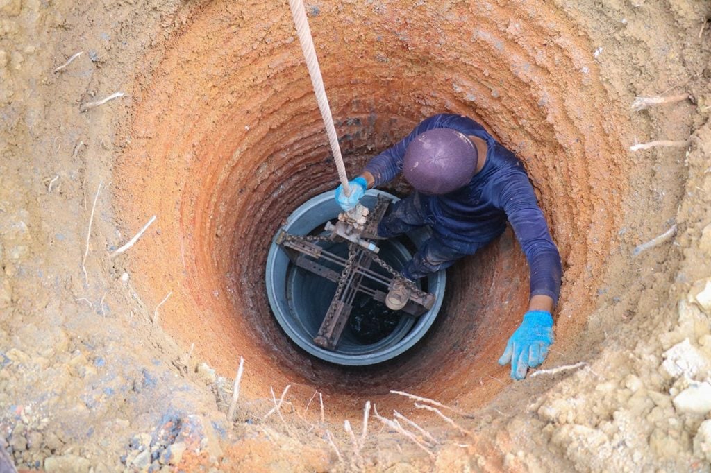 person digging a well