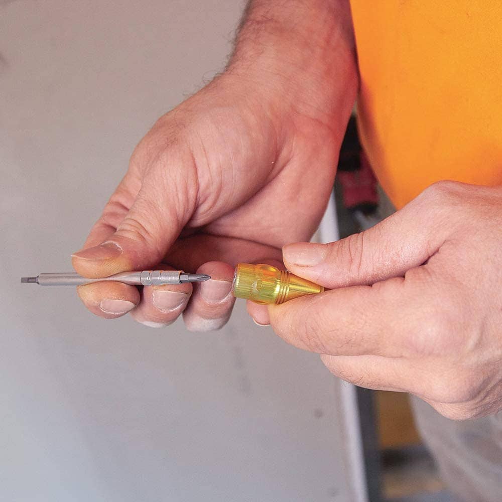 person holding Klein Tools 4-in-1 Electronics Pocket Screwdriver