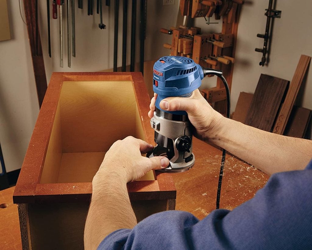 person using Bosch GKF125CEN Colt Variable-Speed Palm Router Tool