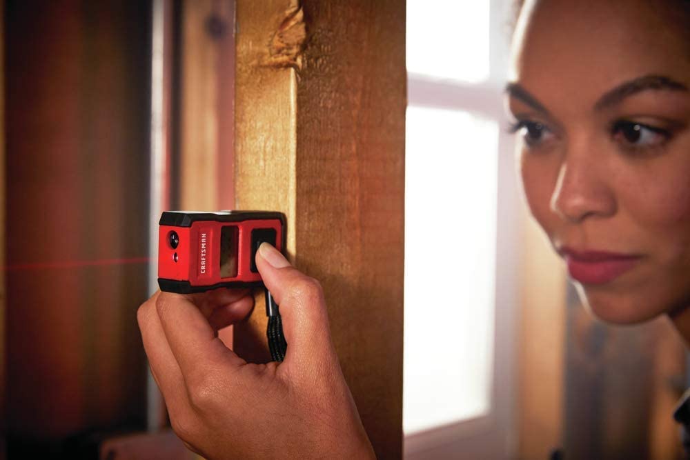 person using CRAFTSMAN CMHT77637 Laser Measure Tool