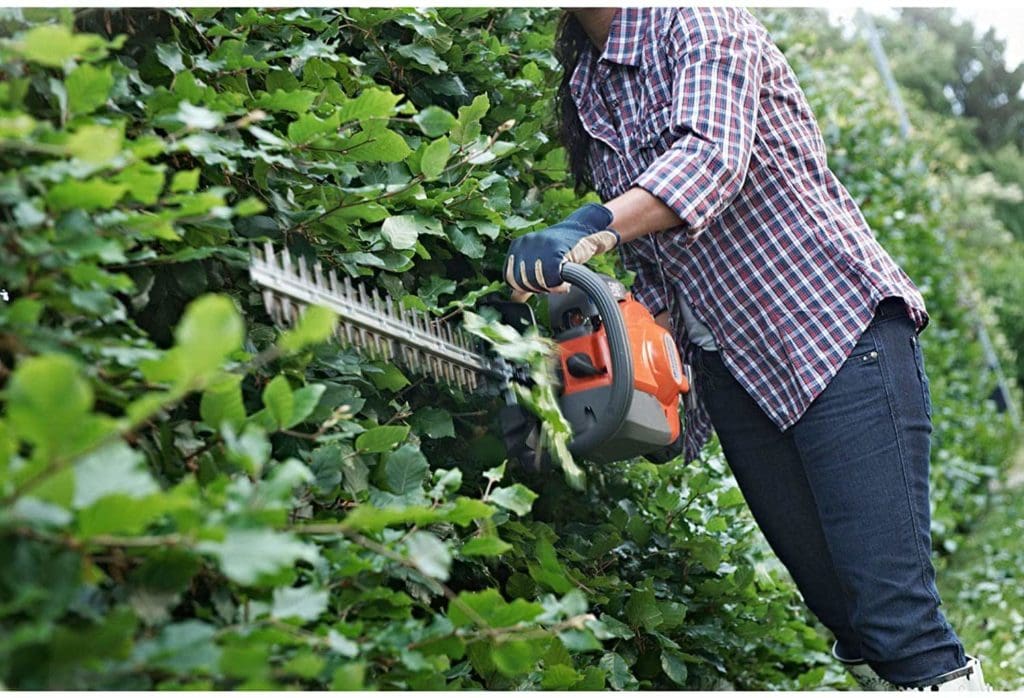 person using Husqvarna 9665324-02 Dual Action hedge Trimmer