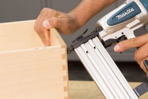person using Makita AF505N Brad Nailer