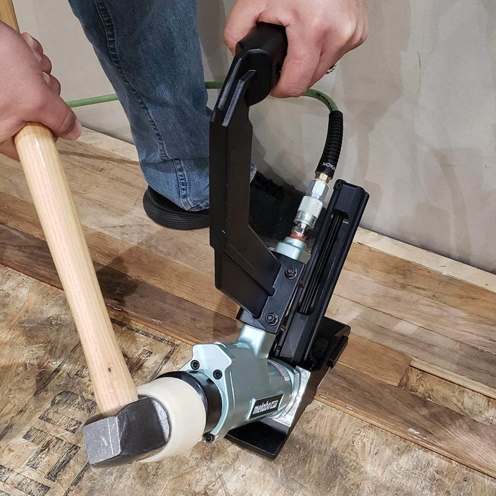 person using Metabo N5010AB HPT Flooring Stapler