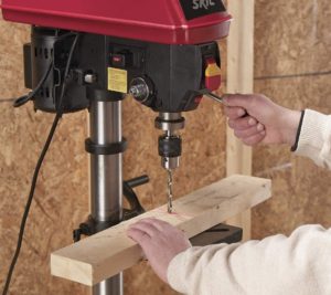 person using SKIL 3320-01 Drill Press