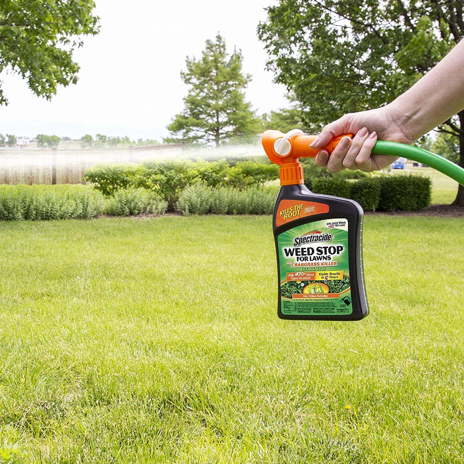 person using Spectracide Weed Stop For Lawns + Crabgrass Killer