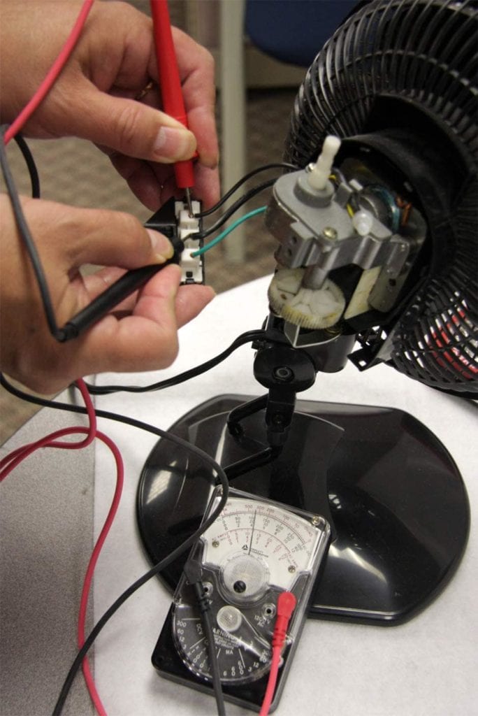 person using Gardner Bender Analog Multimeter