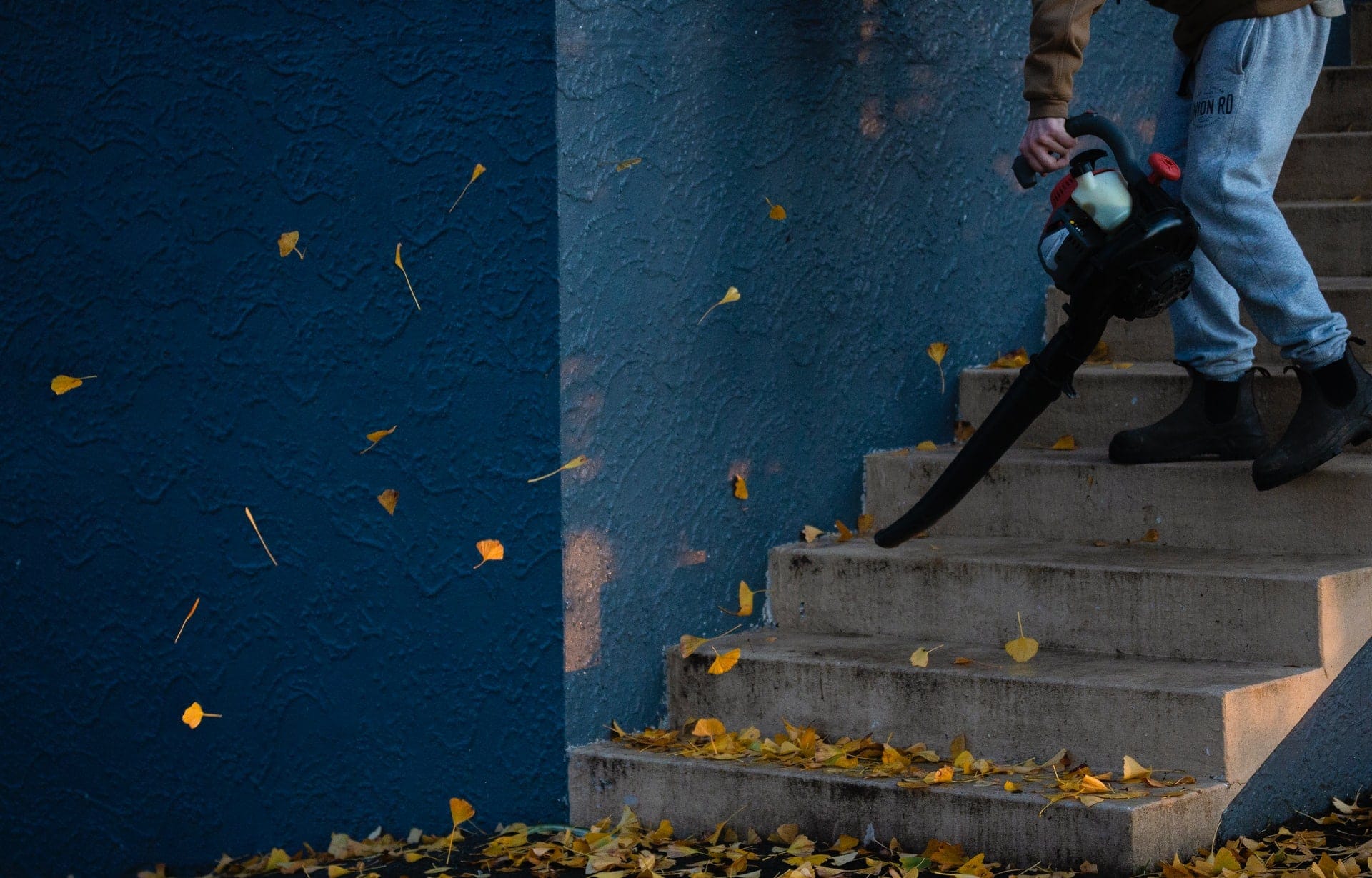 person using leaf blower in the stairs