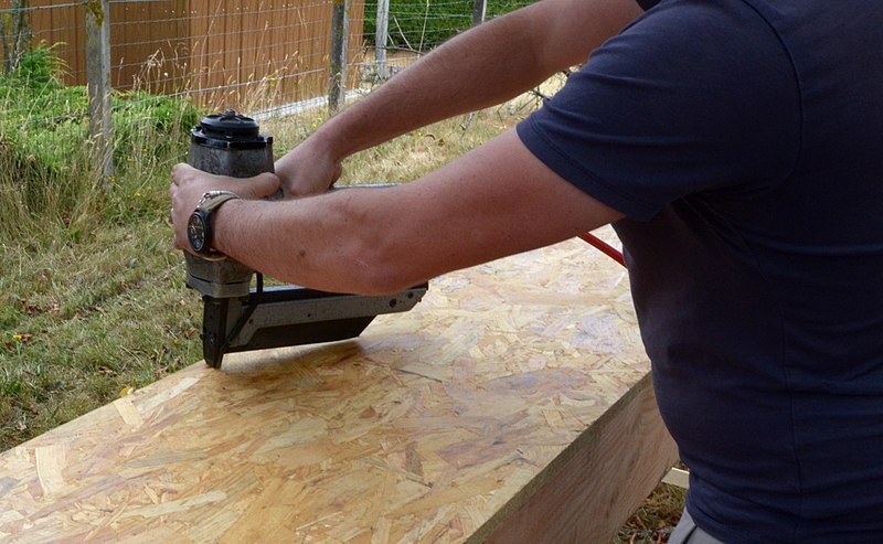 person using nail gun