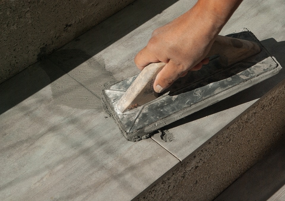 person using tile trowel