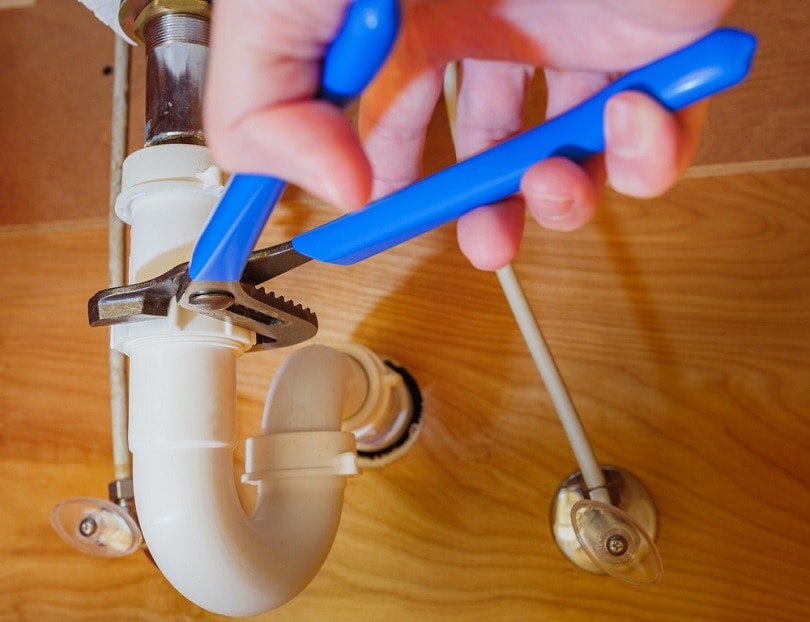 plumber-using-adjustable-wrench-to-repair-bathroom-sink_The-Toidi_shutterstock