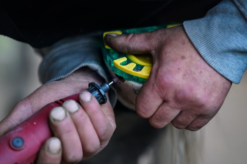 man using rotary tool grinder