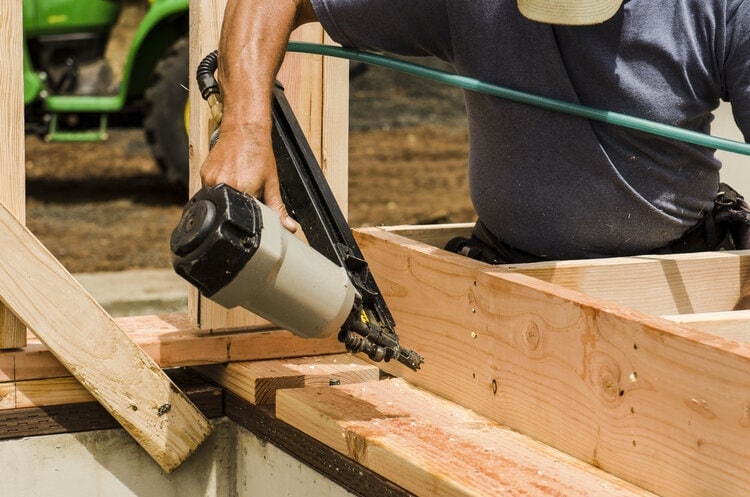 nail gun being used to build house