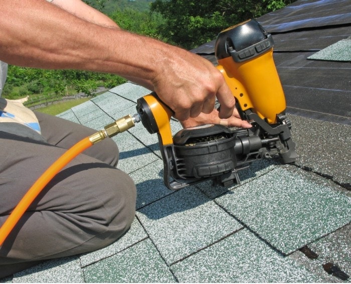 man using nail gun