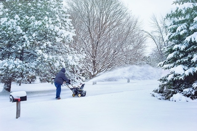 man snow blowing