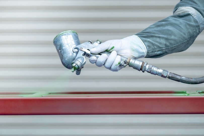 spraying paint on metal work_Naronta_shutterstock