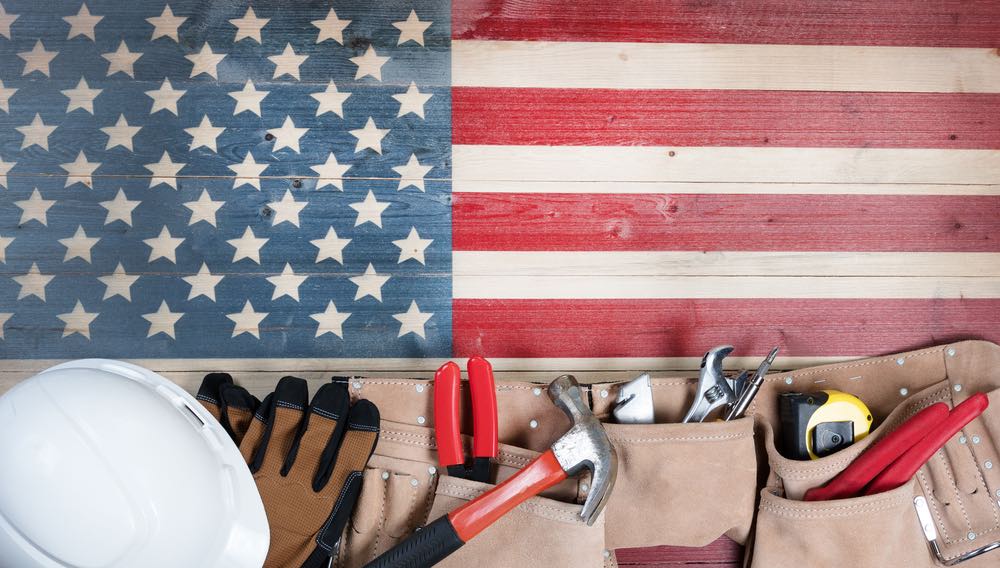 tools, toolbelt, hard hat on a rustic american flag