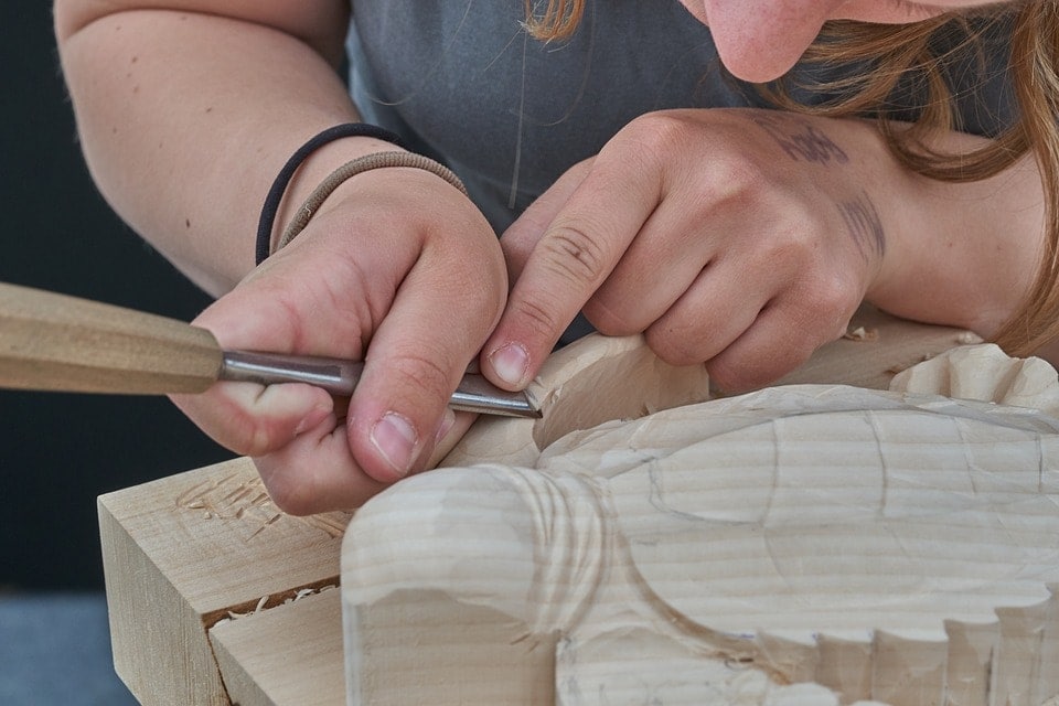 woman carving wood close up