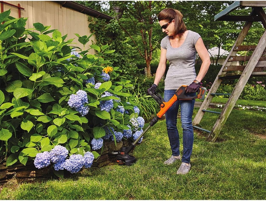 woman using BLACK+DECKER LSTE523 Li-On String Trimmer