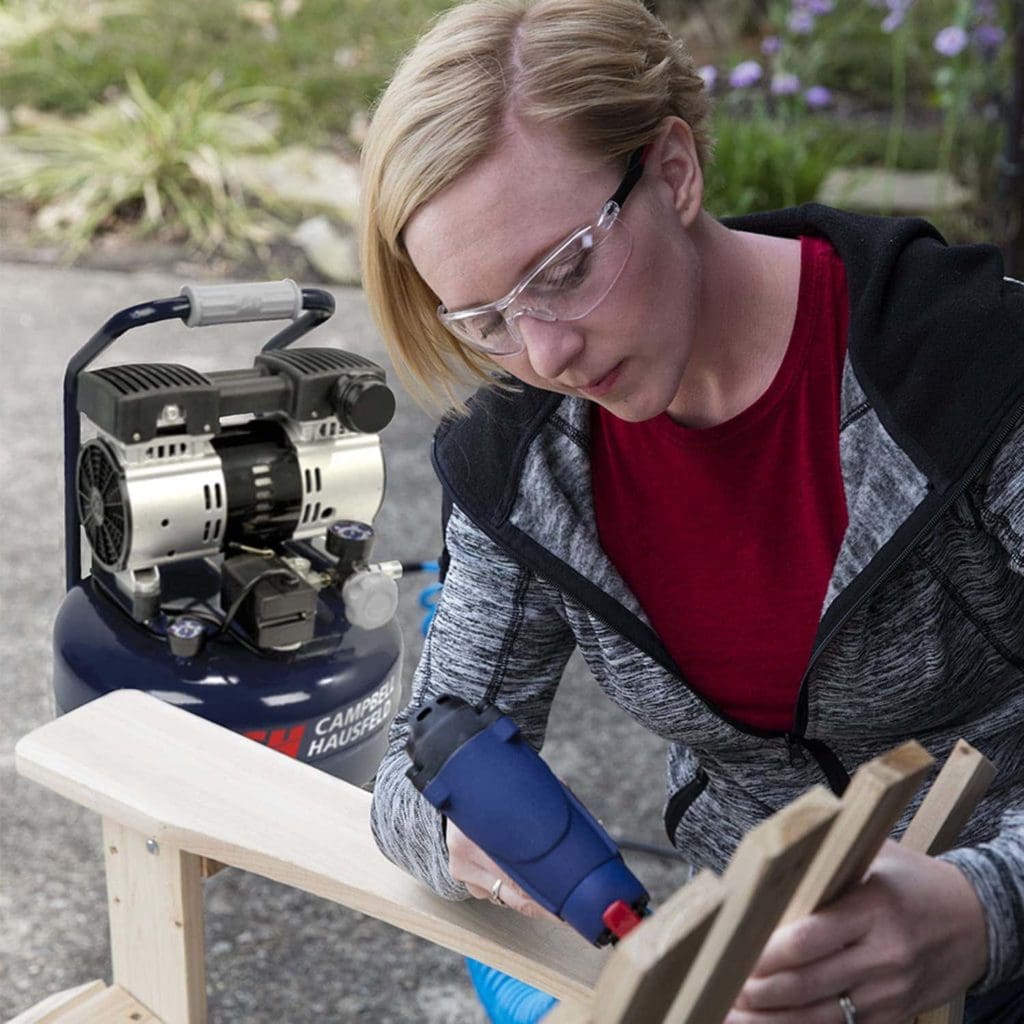 woman using Campbell Hausfeld DC060500 Portable Air Compressor
