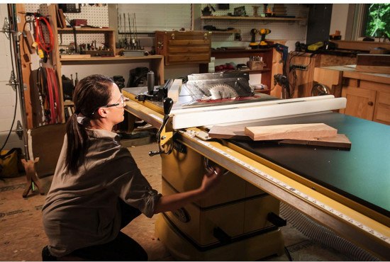 woman using a cabinet table saw