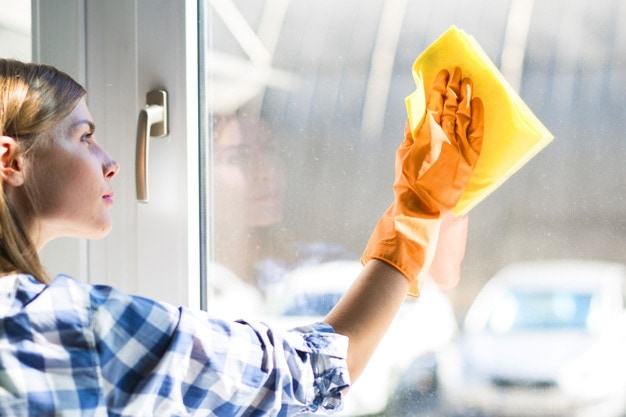 woman wiping glass window