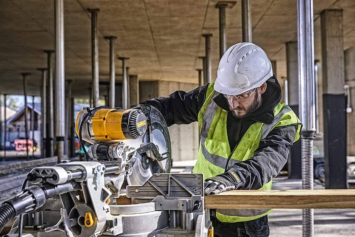 worker using DEWALT Sliding Compound Miter Saw