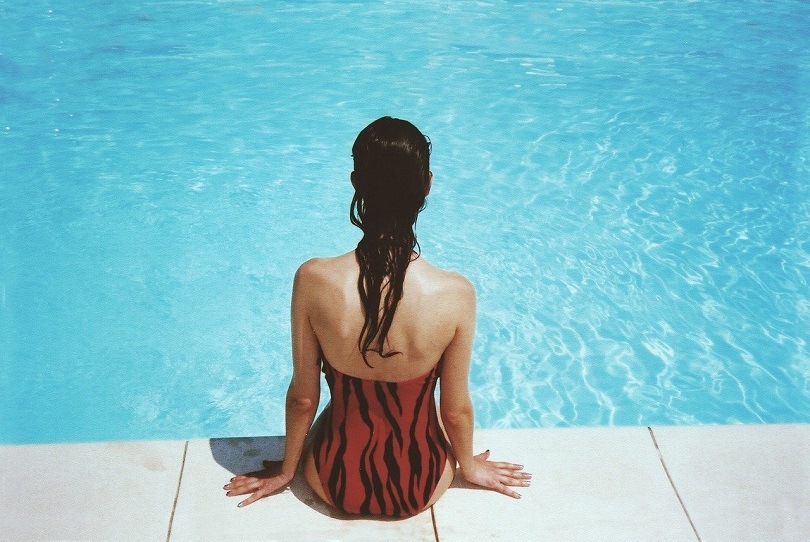 Woman sitting on poolside