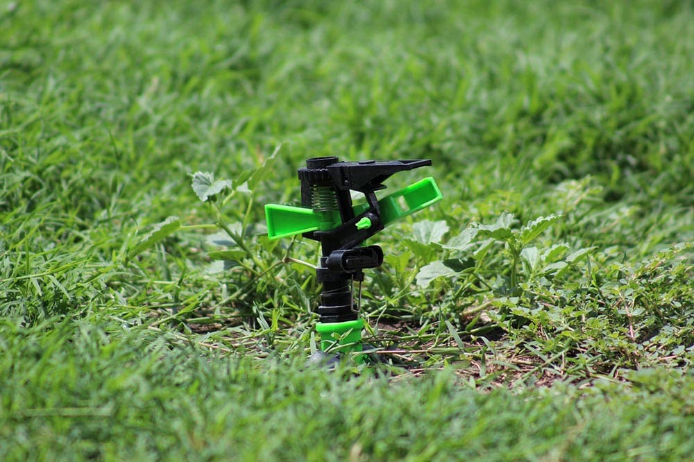 a water sprinkler in the grass