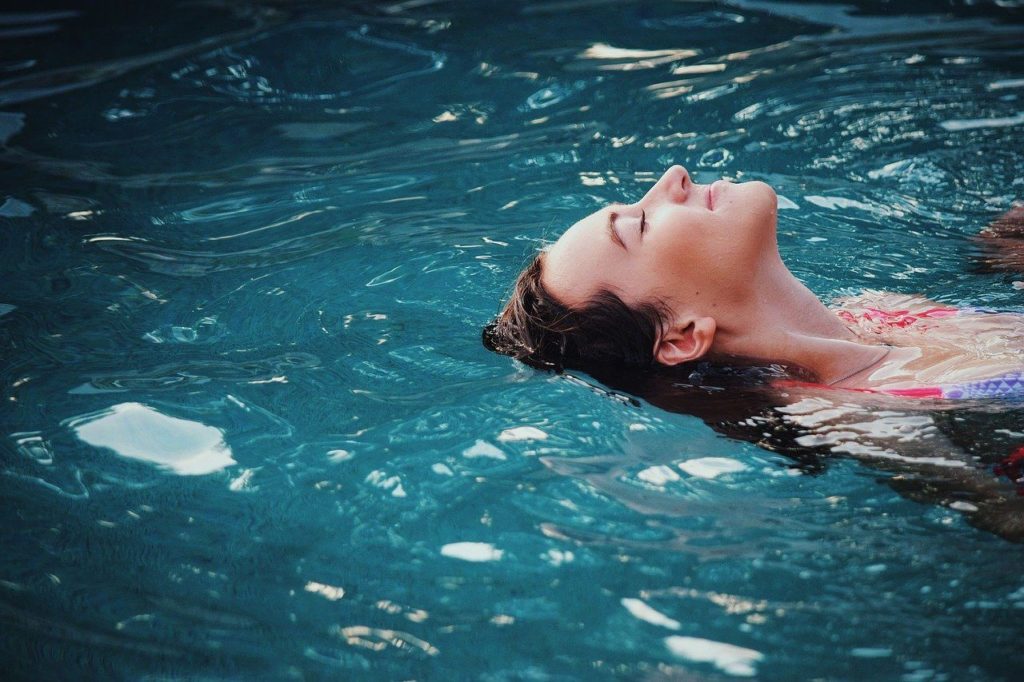 woman floating in the pool