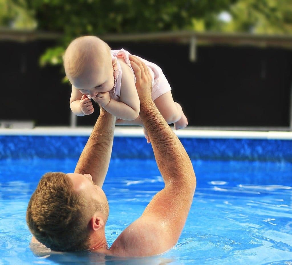 man and baby in the pool