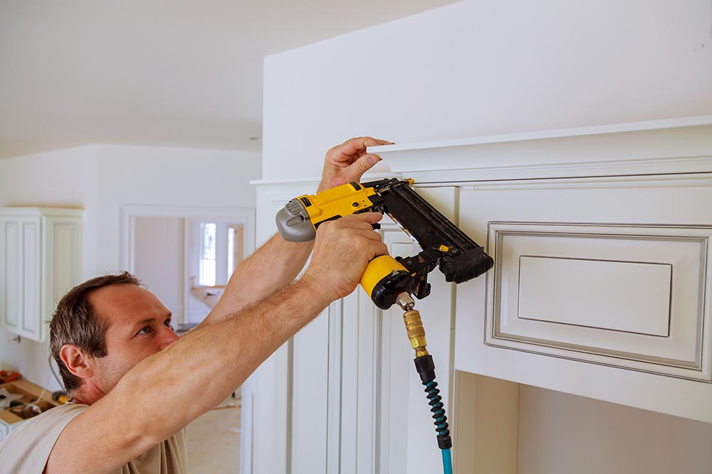 man installing crown molding