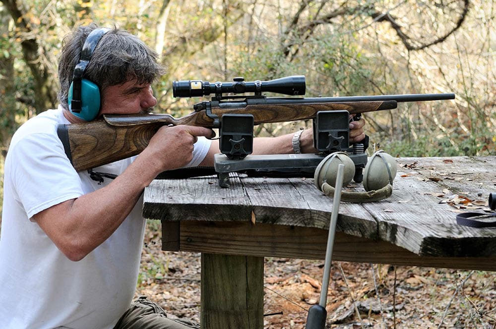 Man sighting on a shooting bench