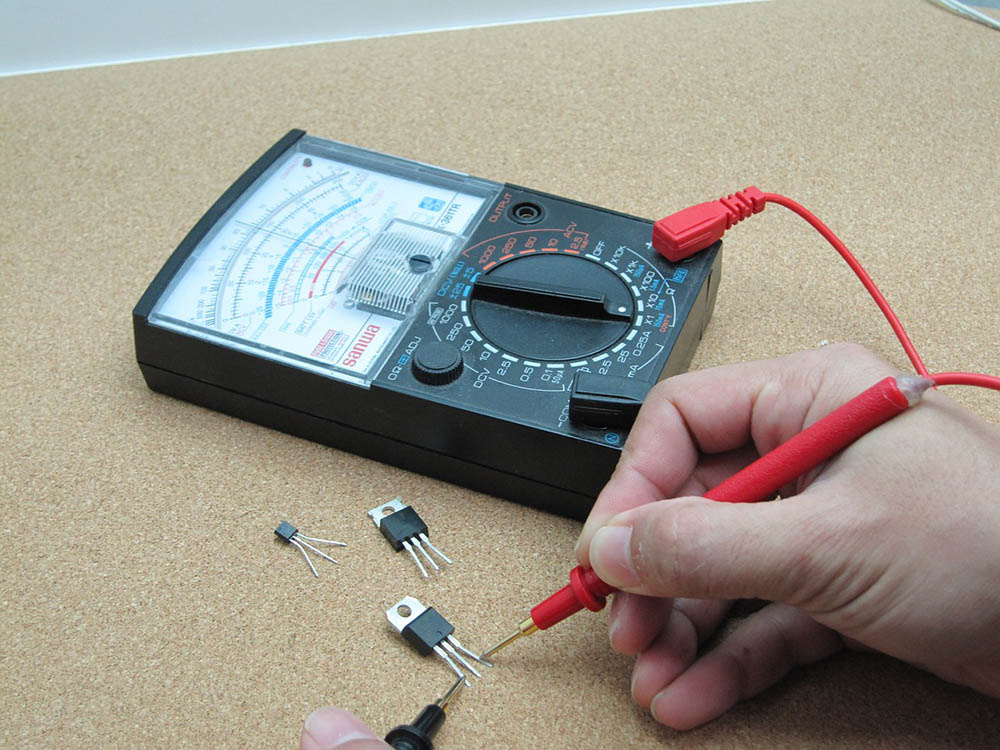 person using a multimeter