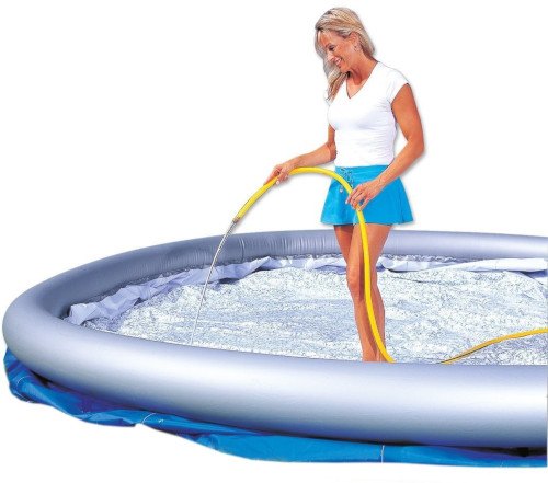woman refilling water on pool