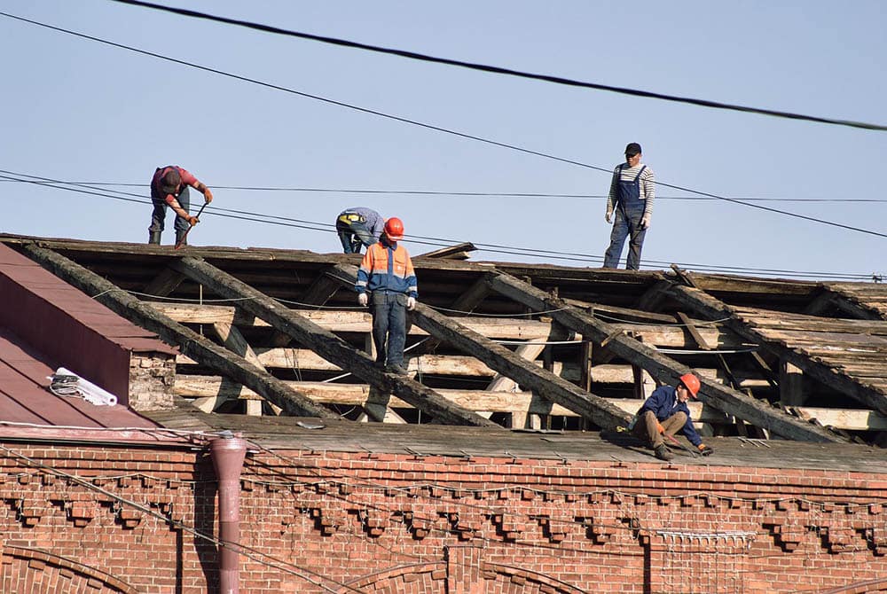 men on top of the roof
