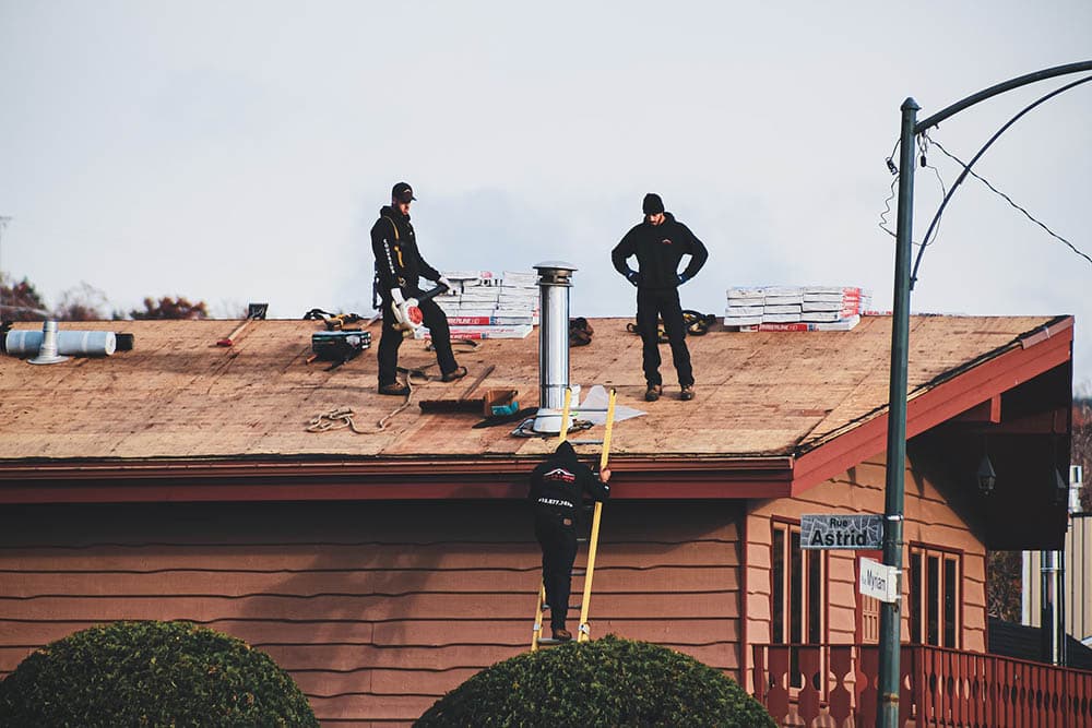 men repairing roof