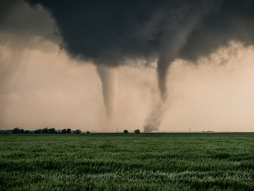 a pair of tornadoes take a destructive path through farmyards