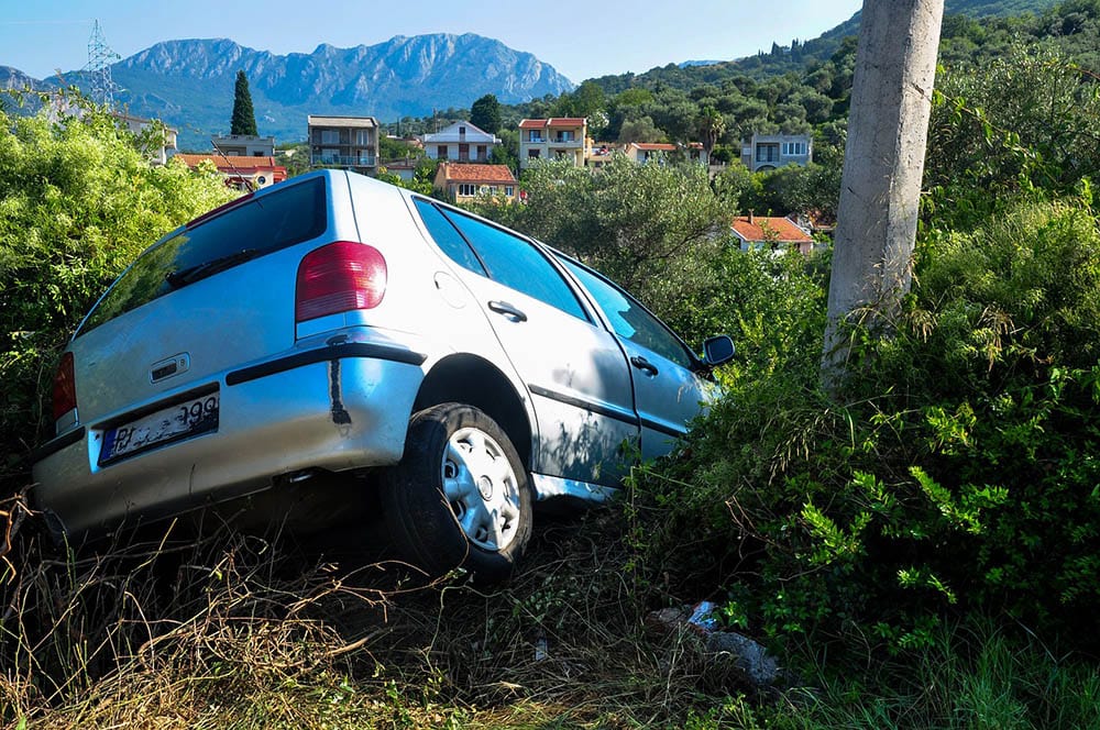 car crashed on the side of the road