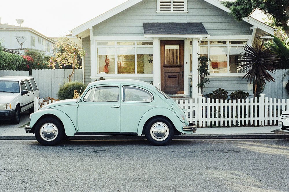 house with vintage cars