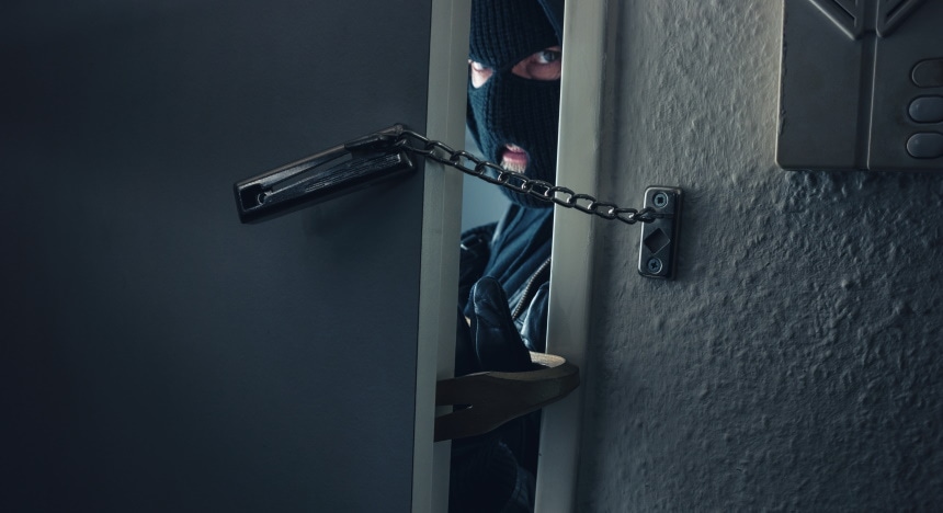 man breaking house door