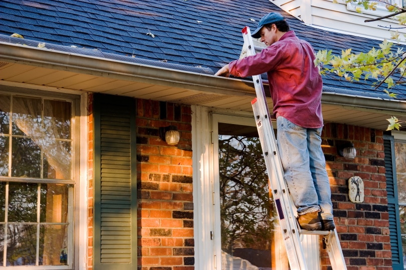 man cleaning the roof