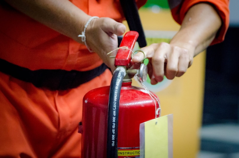 man holding fire extinguisher
