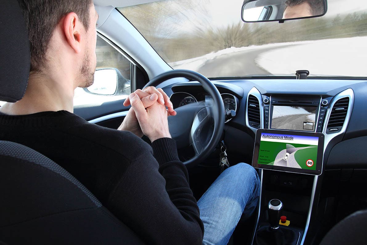 man riding a self driving car