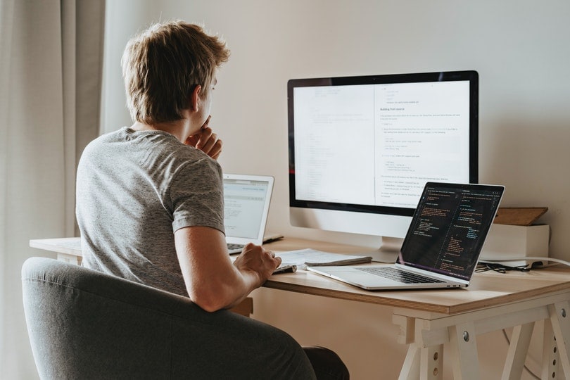 man sitting in front of his computers